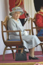 Britain's Queen Elizabeth II watches a ceremony to mark her official birthday at Windsor Castle, Windsor, England, Saturday June 12, 2021. In line with government advice The Queen's Birthday Parade, also known as Trooping the Colour, will not go ahead in its traditional form. ( Eddie Mulholland/Pool via AP)