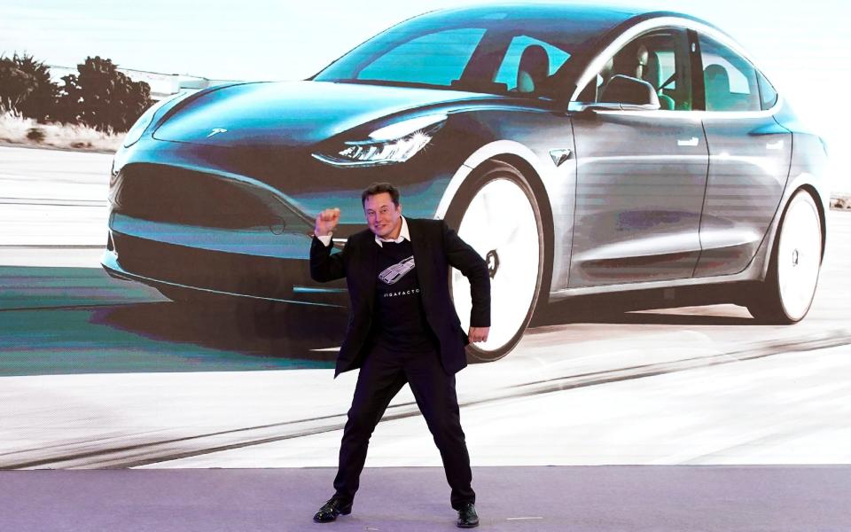 Dancing in front of a giant picture of your own car is a sure sign you've made it in this world - REUTERS
