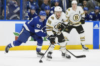 Boston Bruins right wing David Pastrnak (88) gets past Tampa Bay Lightning center Brayden Point (21) during the first period of an NHL hockey game Wednesday, March 27, 2024, in Tampa, Fla. (AP Photo/Chris O'Meara)