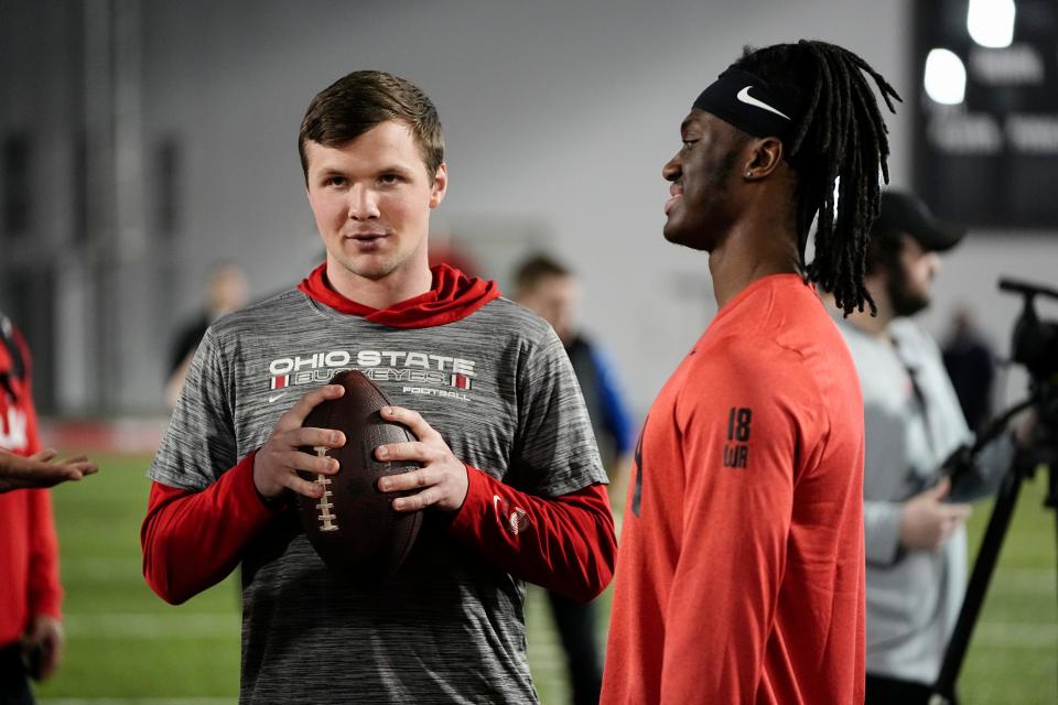 Ohio State Buckeyes quarterback Kyle McCord talks to wide receiver Marvin Harrison Jr. during Ohio State football’s pro day at the Woody Hayes Athletic Center in Columbus on March 22, 2023.