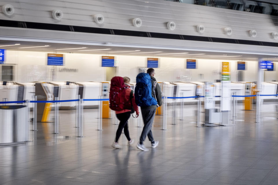 Passengers walk through a terminal at the airport in Frankfurt, Germany, Tuesday, Feb. 20, 2024. The trade union Verdi has once again called on Lufthansa ground staff to go on a warning strike. (AP Photo/Michael Probst)