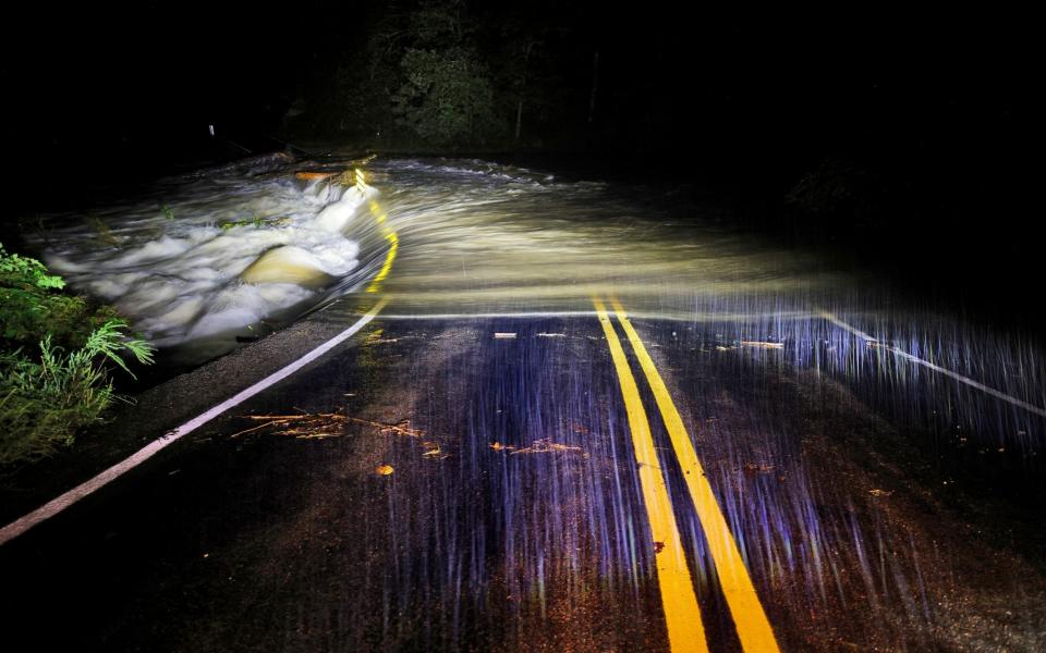 Flood waters wash over Guy Ford Road bridge on the Watauga River as Hurricane Helene approaches in the North Carolina mountains