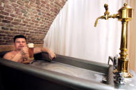 <b>Beer bath: luring tourists</b><br> Wearing only his gold necklace and grasping a large beer, Russian businessman Andrei relaxes voluptuously 17 March 2006 in Chodova Plana near Marianske Lazne (Mariendbad) in a herbal beer bath, the latest Czech "therapeutic" offering the country's first "beer spa". "We Russians love natural products. Here, the beer is the best quality, brewed in the old style without any chemicals, "he explains. Owners of the town's Chodovar brewery, still producing along artisanal lines, launched the beer baths with the target of tempting tourists to their new hotel rather than boosting production. With West Bohemia's six traditional spa resorts competing vigorously for customers with special health programmes and weekend health breaks, the brewery decided it required a different recipe. <b> AFP PHOTO MICHAL CIZEK</b>