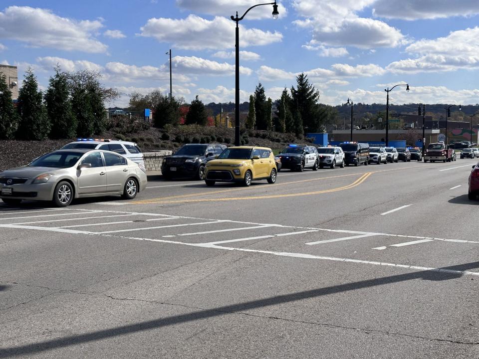 Dozens of officers and state troopers from across several cities in Montgomery and Greene counties gathered outside Miami Valley Hospital Tuesday as Officer Cody Cecil was released from Miami Valley Hospital five days after he was shot while serving a warrant in Clayton. (Scott Kessler/Staff)