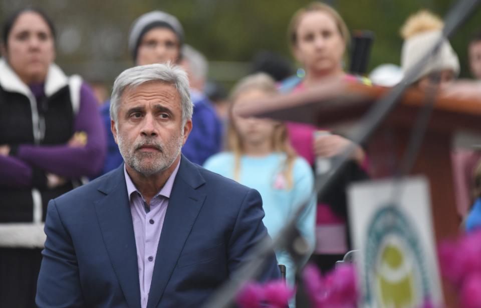 Wilmington mayor Bill Saffo watches as Rachel Knowles speaks during a ceremony in honor of her mother MaryAnn Breault at Holly Tree Racquet Club in Wilmington, N.C., Friday, March 4, 2022. Breault was killed in a domestic violence dispute in front of the club on December 8. The ceremony was held before the Raise A Racquet Against Domestic Violence tennis tournament. [MATT BORN/STARNEWS]