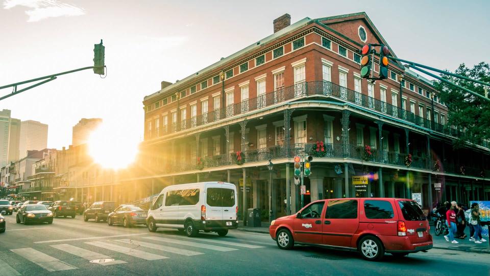 New Orleans - Dec 4, 2017: Afternoon view of brick building with traditional architectural elements with lens flares; at the corner of Decatur and St.