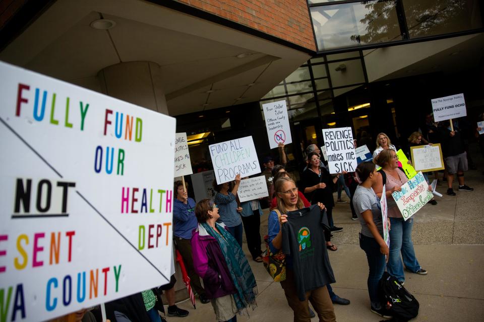 Nearly 100 people protested cuts to the Ottawa County Department of Public Health ahead of the Ottawa County Board of Commissioners meeting Tuesday, Sept. 26, 2023, in West Olive.