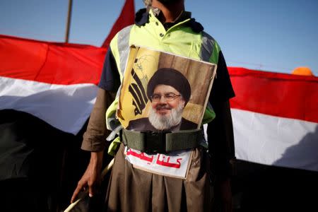 A man sports a poster of Lebanon's Hezbollah leader Sayyed Hassan Nasrallah during a demonstration to commemorate Ashura in Sanaa, Yemen October 12, 2016. REUTERS/Khaled Abdullah
