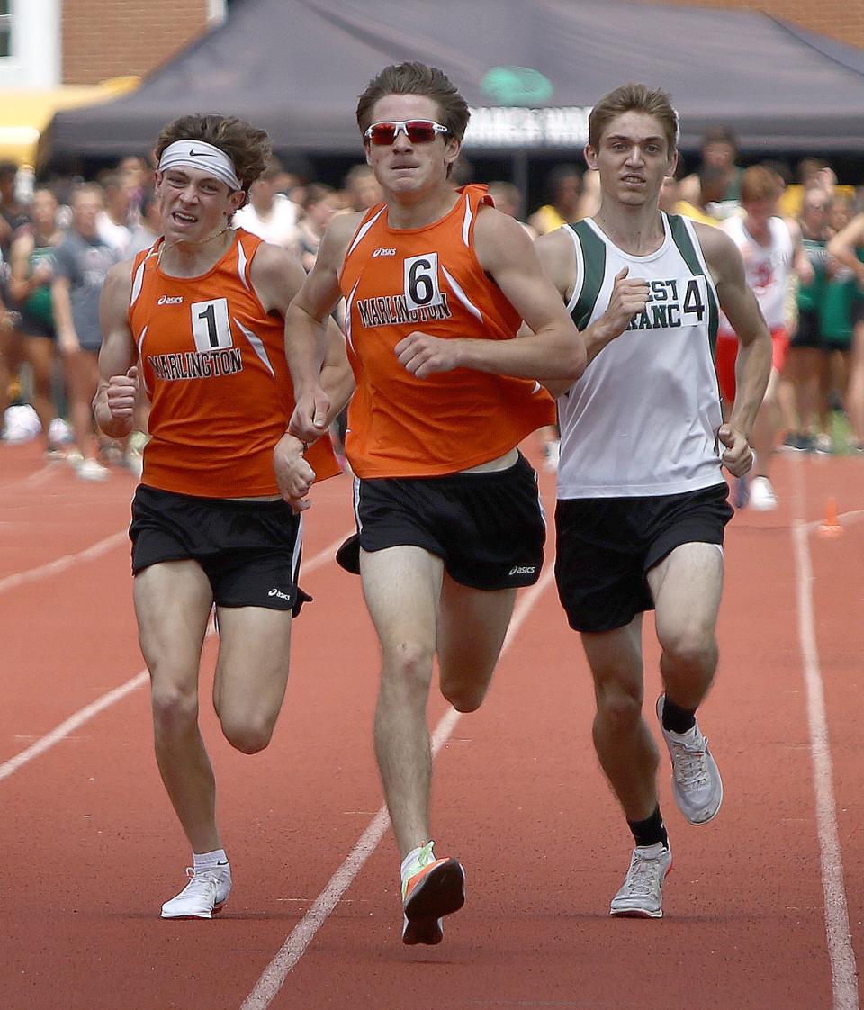 Marlington's Colin Cernansky, left, Liam Blake, and West Branch's Josiah Hicks sprint to the finish line in the boys 1600-meter final at the Division II district track and field finals at Salem Sebo Stadium on Saturday, May 21, 2022.