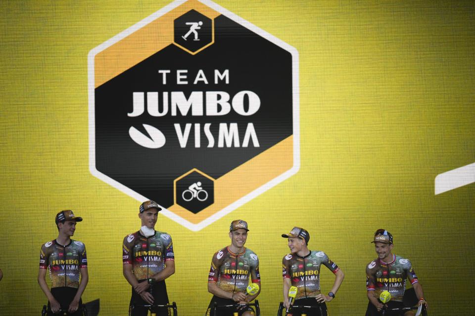 Belgium's Wout van Aert, center, Denmark Joans Vingegaard, second right, Slovenia's Primoz Roglic, far right, and Sepp Kuss of the U.S., far left, line up during the team presentation ahead of the Tour de France cycling race in Copenhagen, Denmark, Wednesday, June 29, 2022. The race starts Friday, July 1, the first stage is an individual time trial over 13.2 kilometers (8.2 miles) with start and finish in Copenhagen. (AP Photo/Daniel Cole)