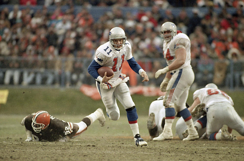 FILE - In this Dec. 19, 1993, file photo, Patriots QB Drew Bledsoe (11) scrambles for nine yards against the Cleveland Browns in Cleveland. After being the No. 1 overall pick, Bledsoe started right away for the Patriots. He started 12 games as a rookie for Bill Parcells' Patriots, going 5-7 and finishing with 15 TDs and 15 INTs. He carved out a terrific career for himself and was selected to four Pro Bowls. (AP Photo/Mark Duncan)