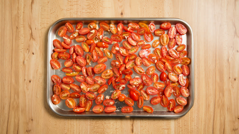 halved tomatoes on baking sheet 