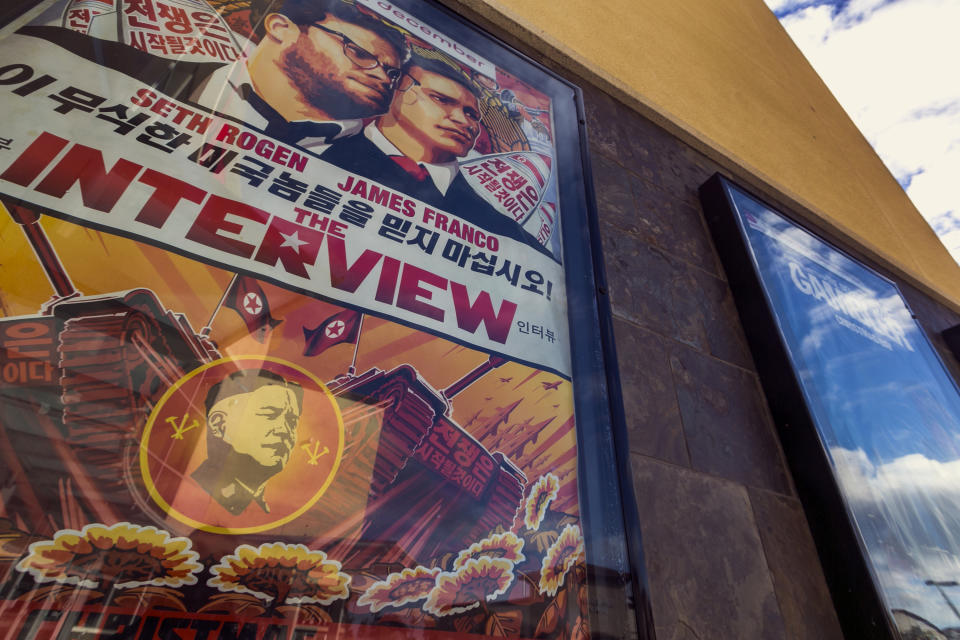 FILE - This Dec. 17, 2014, file photo shows a movie poster for the movie "The Interview" on display outside the AMC Glendora 12 movie theater, in Glendora, Calif. A computer programmer working for the North Korean government was charged with devastating cyberattacks that hacked Sony Pictures Entertainment and unleashed the WannaCry ransomware virus that infected computers in 150 countries and crippled parts of the British health care system, federal prosecutors said Thursday, Sept. 6, 2018. (AP Photo/Damian Dovarganes, File)