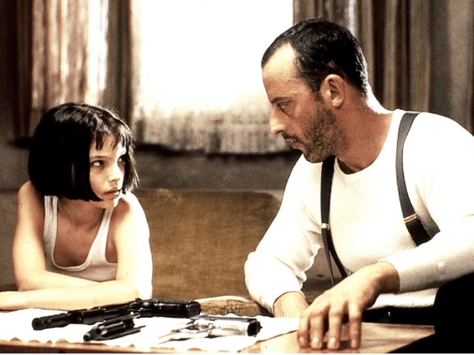 Natalie Portman sitting next to Jean Reno, both wearing white shirts