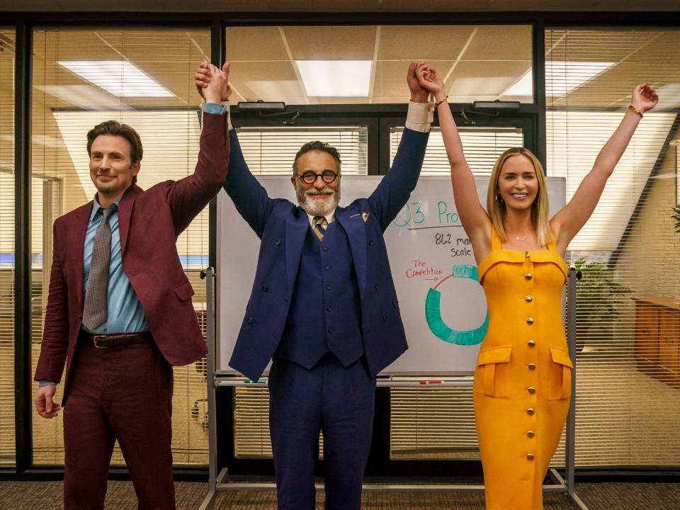 Chris Evans, Andy Garcia, Emily Blunt raising their hands in an office