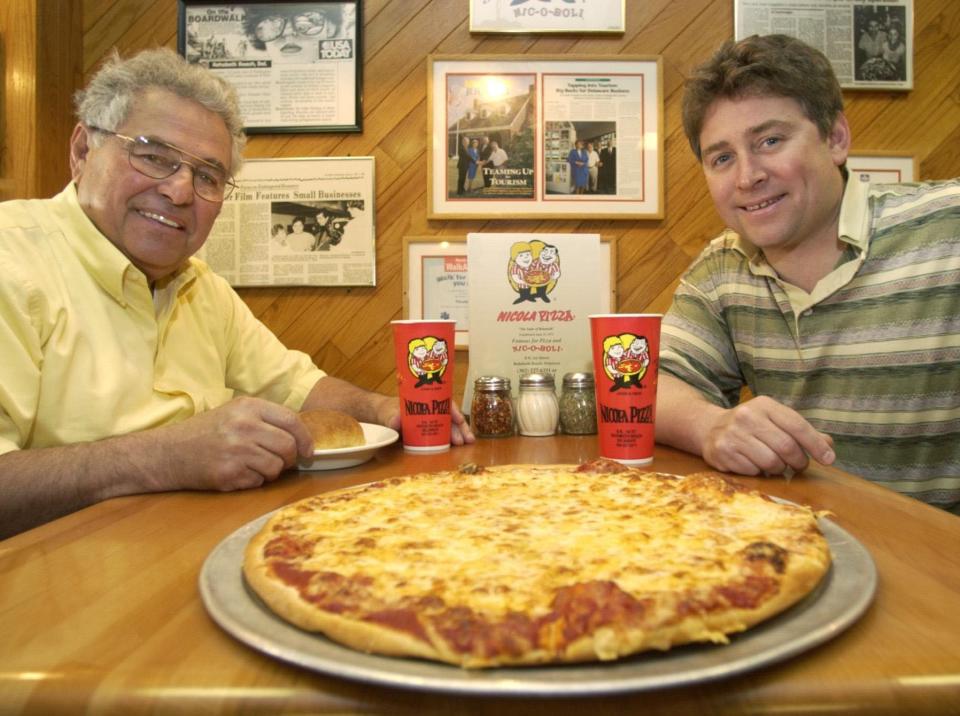 In this May 17, 2005, photo, Nick Caggiano, then 68, and his son, Nick Jr., then 39, sit at their flagship Rehoboth Beach restaurant, Nicola Pizza. The Caggianos closed their two restaurants, moved from Rehoboth and opened a new Nicola Pizza in Lewes in October 2022.