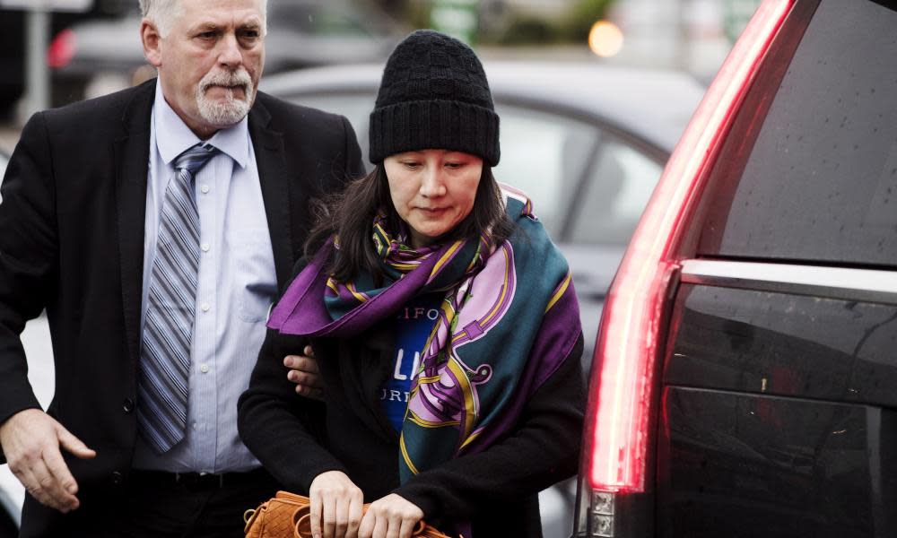 Huawei’s chief financial officer, Meng Wanzhou, arriving at a parole office with a security guard in Vancouver, British Columbia, on Wednesday