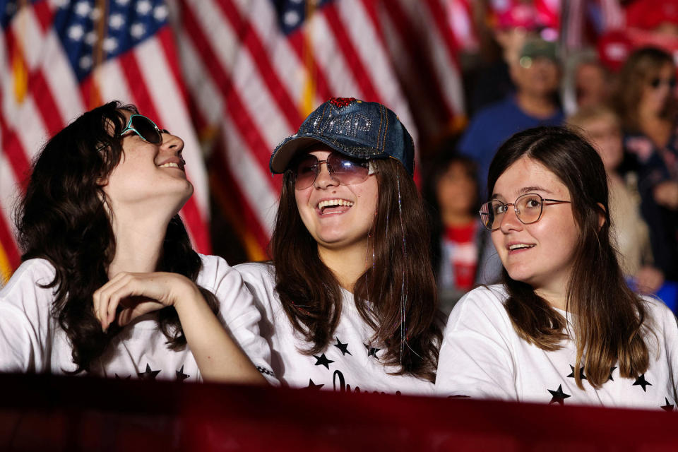 Three supporters smile at a Trump rally. (Lindsay DeDario / Reuters file)