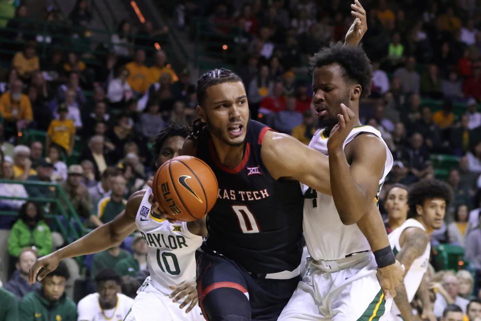 Texas Tech forward Kevin Obanor (0) drives past Baylor guard LJ Cryer while setting up a play in the first half of an NCAA college basketball game, Saturday, Feb. 4, 2023, in Waco, Texas. (AP Photo/Rod Aydelotte) ORG XMIT: TXRA106