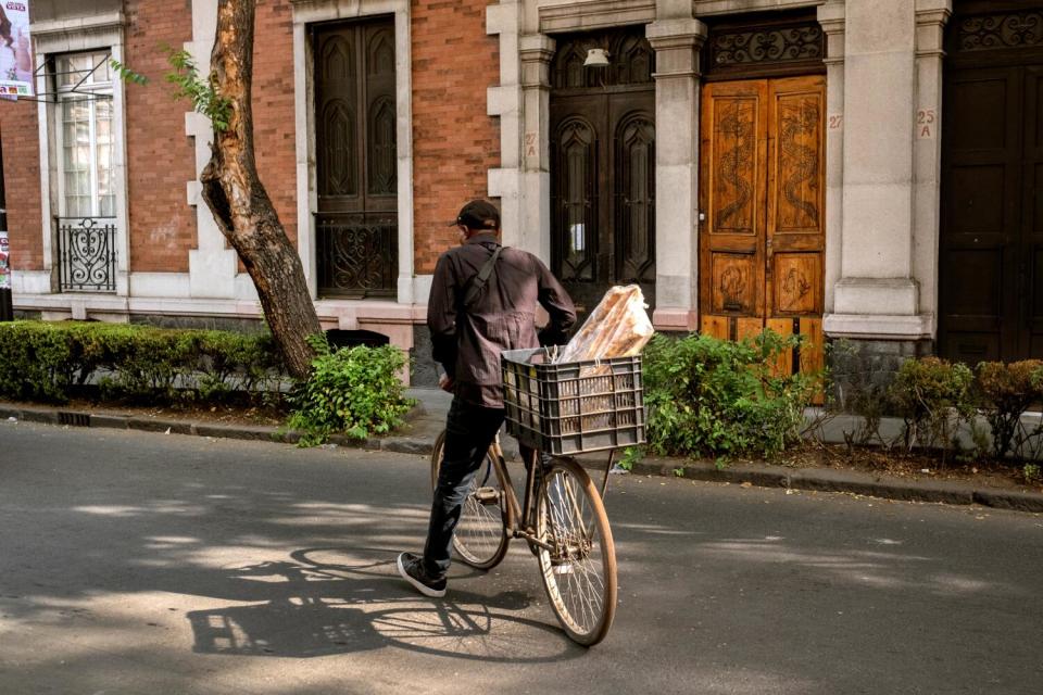 Marc Arthur Garcon, 52, departs the market to fulfill a meat order. Formerly a photographer