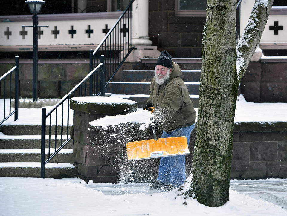 Ron Williams, a volunteer at First United Brethren Church in Johnstown, Pa. shovels snow from the sidewalk outside the church on Monday, Feb. 1, 2021. (Todd Berkey/The Tribune-Democrat via AP)