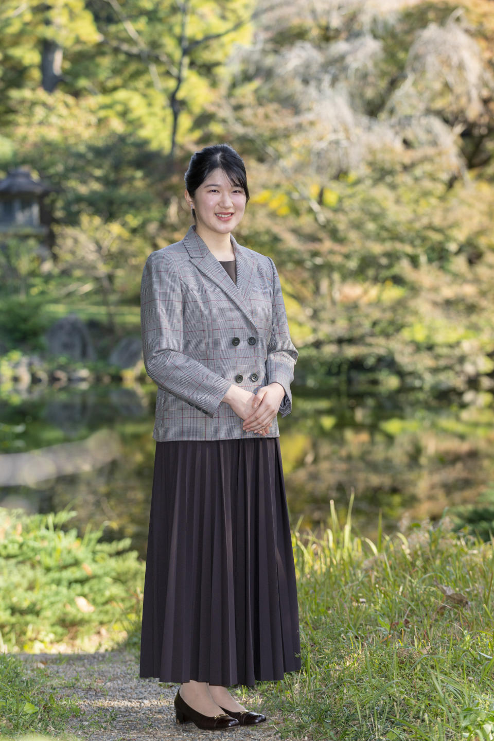 In this photo provided by the Imperial Household Agency of Japan, Princess Aiko, daughter of Emperor Naruhito and Empress Masako, strolls the garden of the Imperial Residence at the Imperial Palace in Tokyo on Nov. 14, 2021, ahead of her 20th birthday on Dec. 1, 2021. (The Imperial Household Agency of Japan via AP)