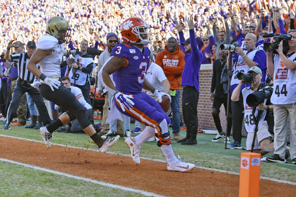 Clemson's Amari Rodgers (3) scores a touchdown while defended by Wofford's Keyvaun Cobb during the first half of an NCAA college football game, Saturday, Nov. 2, 2019, in Clemson, S.C. (AP Photo/Richard Shiro)