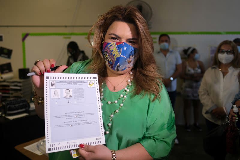 Resident Commissioner of Puerto Rico in Washington Jenniffer Gonzalez shows the press her ballot in Carolina