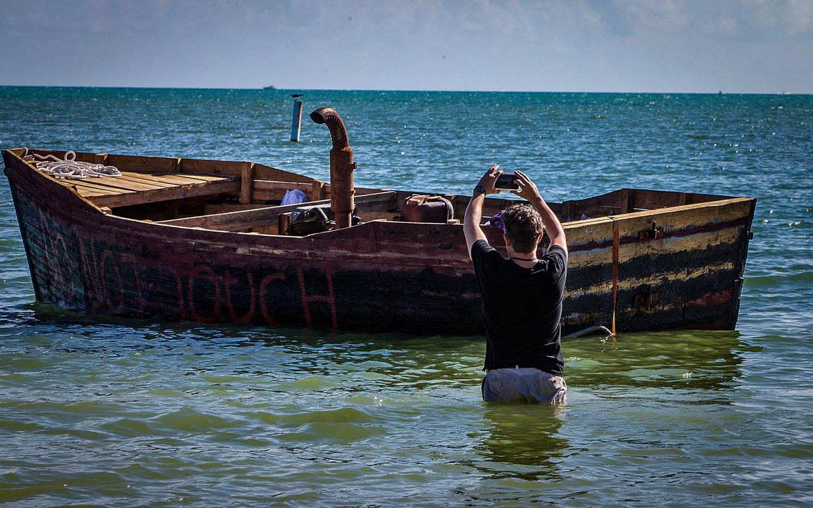 Miami Herald reporter David Goodhue takes a closer look at a Cuban migrant vessel anchored in the shallow waters off Sombrero Beach on Jan. 2, 2023. The vessel arrived weeks earlier to the Florida Keys.