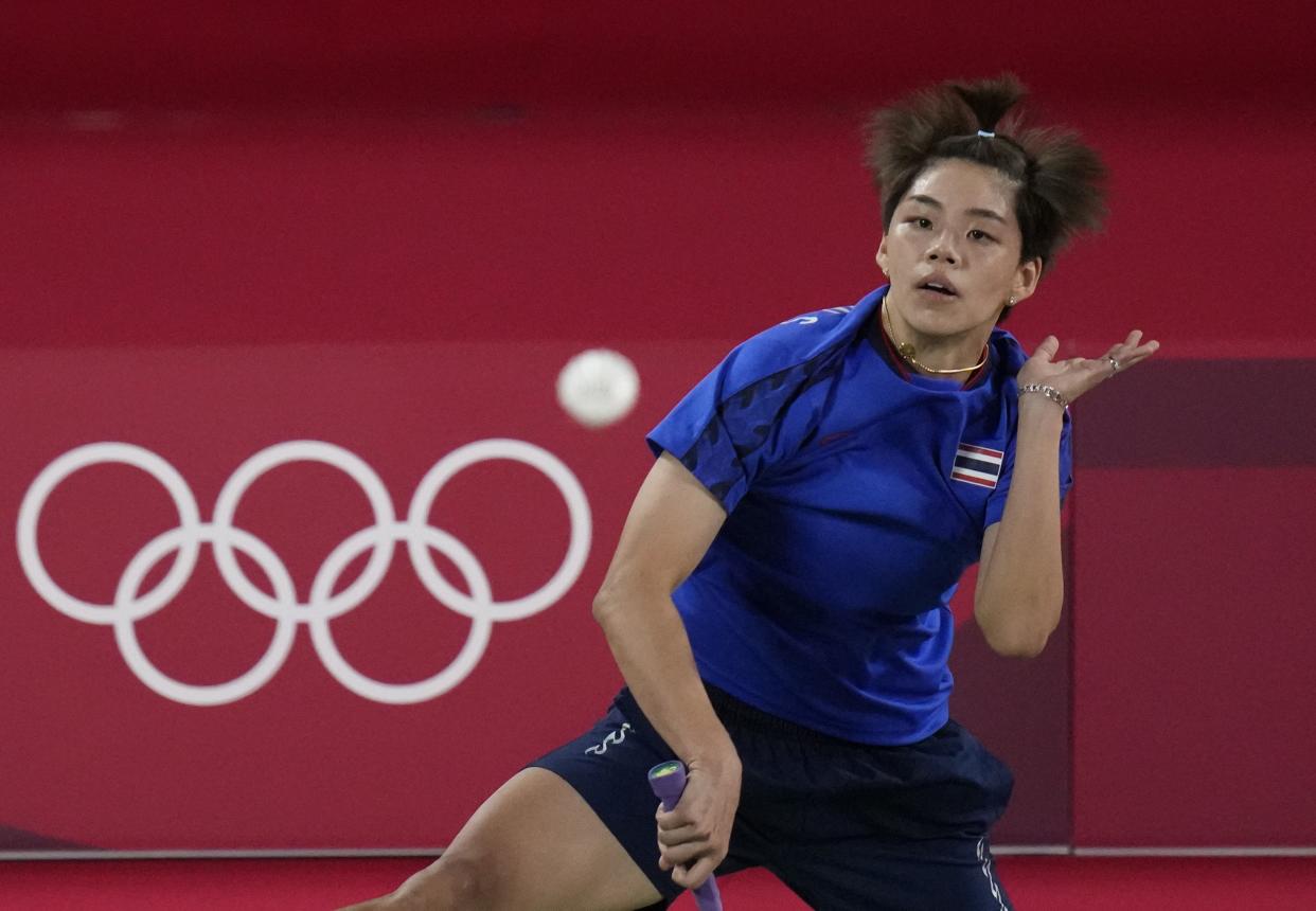 Thailand's Sapsiree Taerattanachai plays with compatriot Dechapol Puavaranukroh against Britain's Marcus Ellis and Lauren Smith during their mixed doubles group play stage badminton match at the 2020 Summer Olympics, Monday, July 26, 2021, in Tokyo, Japan.