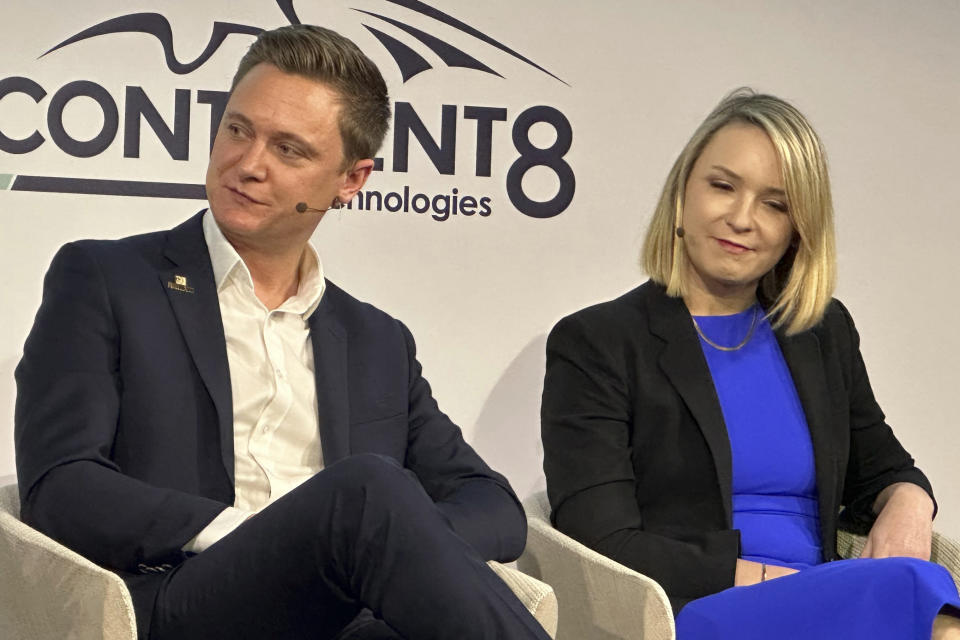 Oliver Bartlett, left, and Karolina Pelc, right, listen to speakers at a forum on the future of online gambling in New York on Thursday, March 7, 2024. Panelists at the next.io forum agreed the future of online gambling will be more social, more engaged with players and more targeted to their individual interests. (AP Photo/Wayne Parry)