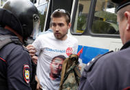 <p>Riot police detain a man dressed in a t-shirt depicting opposition leader Alexei Navalny, during the Navalny-led anti-corruption protest in central Moscow, Russia, June 12, 2017. (Maxim Shemetov/Reuters) </p>