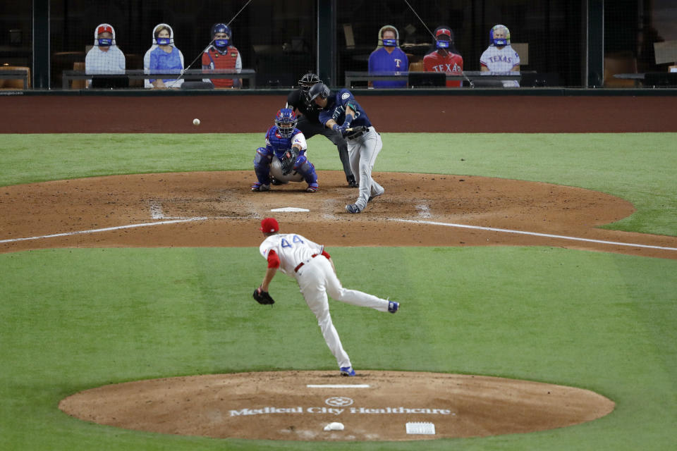 Seattle Mariners' Dylan Moore singles off a pitch from Texas Rangers' Kyle Gibson as catcher Robinson Chirinos (61) and umpire Edwin Moscoso watch during the third inning of a baseball game in Arlington, Texas, Monday, Aug. 10, 2020. (AP Photo/Tony Gutierrez)