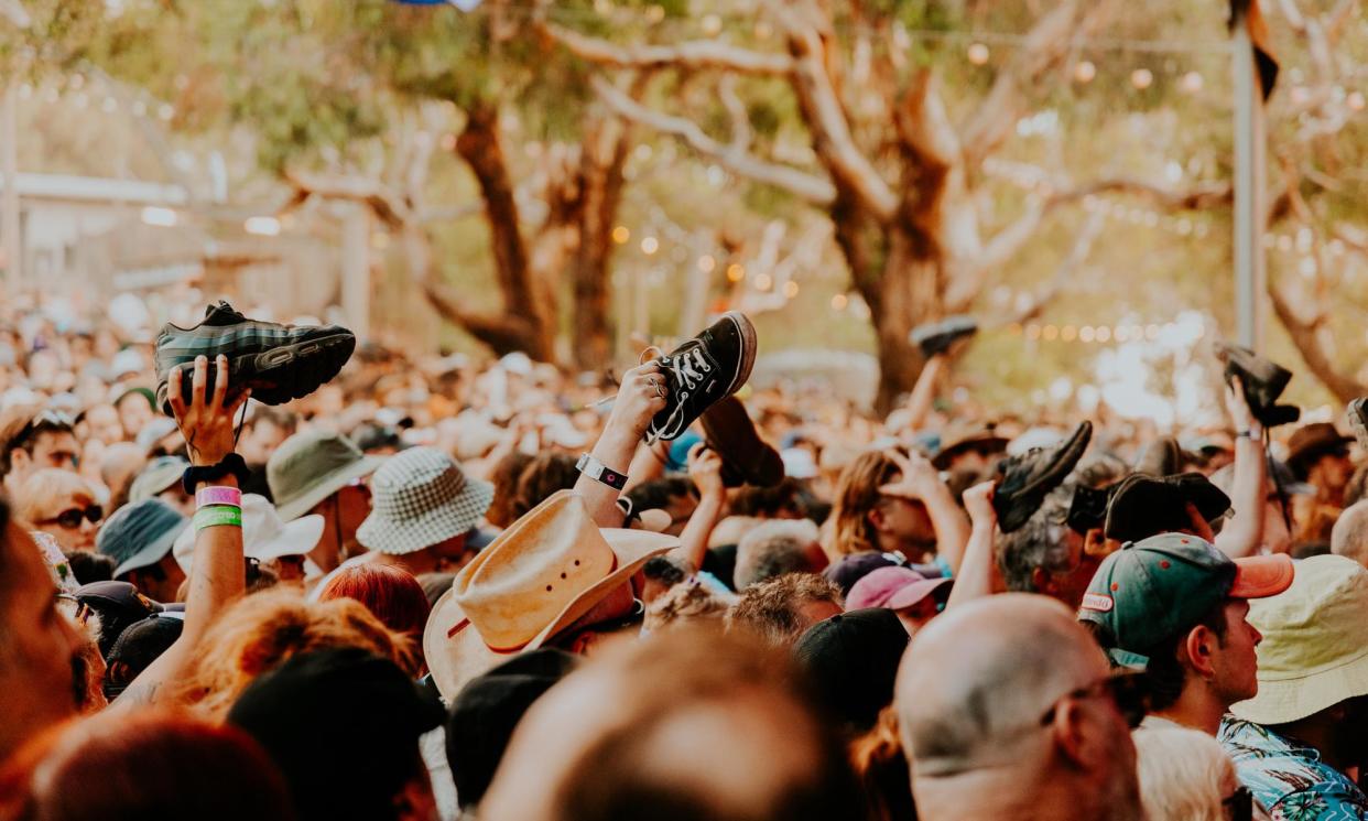<span>Festival-goers raise their shoes in appreciation at Golden Plains festival – a traditional display of approval.</span><span>Photograph: Eloise Coomber</span>