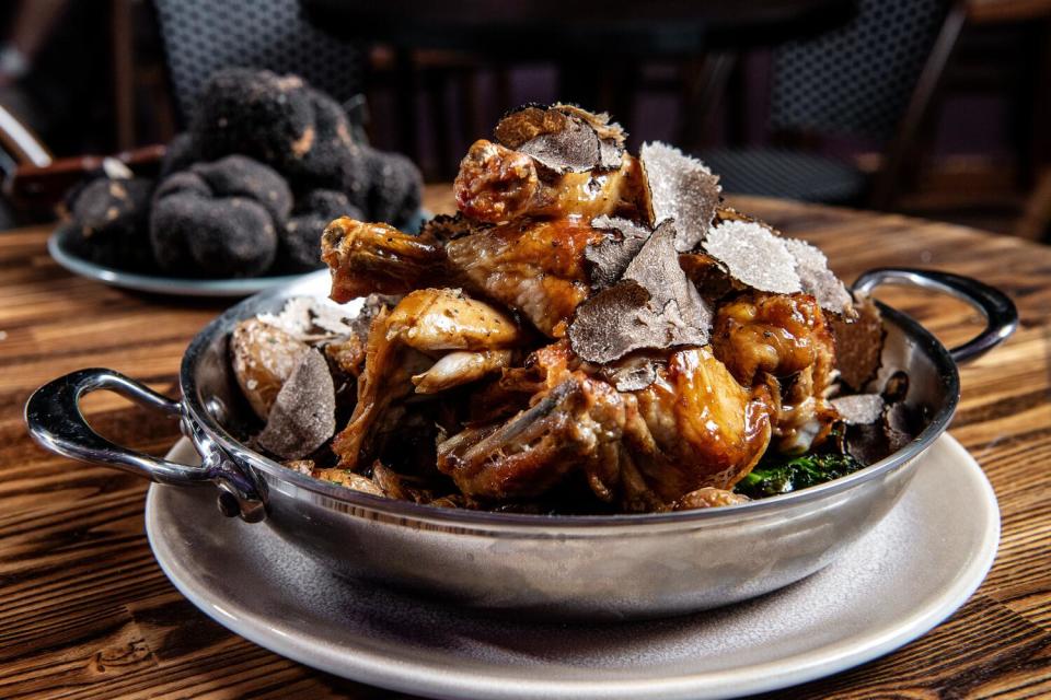 Truffles on a chicken dish with potatoes and broccoli.