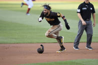 San Diego Padres' Fernando Tatis Jr., left, runs toward third after he stole second and advanced to third on a throwing error by Washington Nationals catcher Rene Rivera (not shown) during the first inning of a baseball game, Friday, July 16, 2021, in Washington. (AP Photo/Nick Wass)