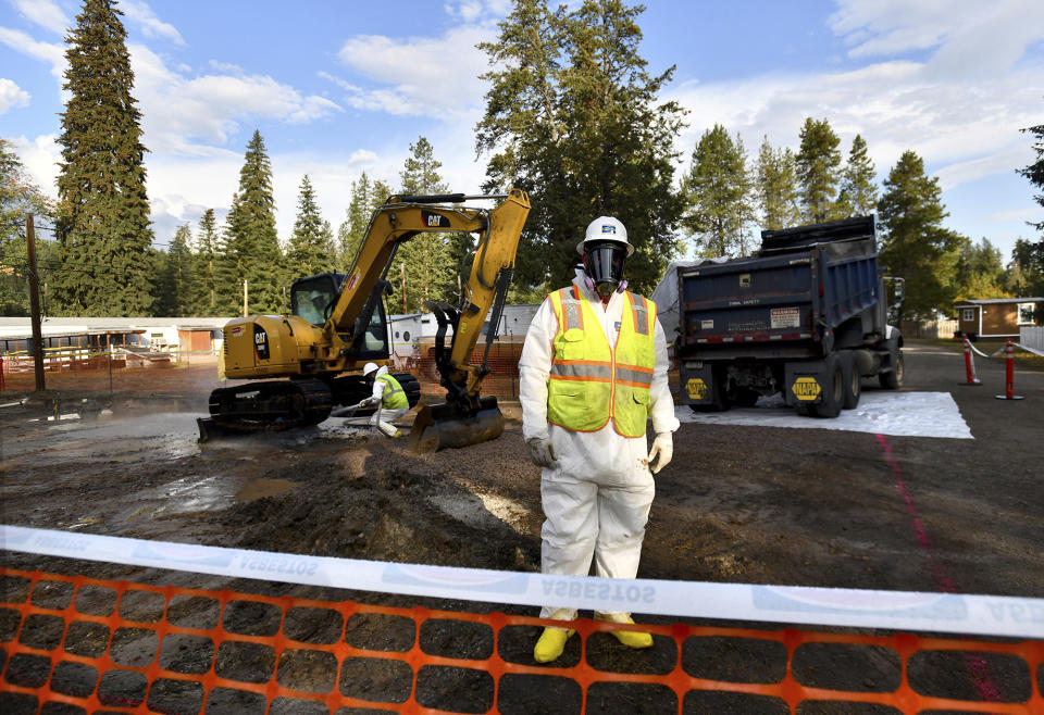 FILE - Environmental cleanup specialists work at one of the last remaining residential asbestos cleanup sites in Libby, Montana, in mid-September. BNSF Railway attorneys are expected to argue before jurors Friday, April 19, 2024, that the railroad should not be held liable for the lung cancer deaths of two former residents of the asbestos-contaminated Montana town, one of the deadliest sites in the federal Superfund pollution program. (Kurt Wilson/The Missoulian via AP, File)