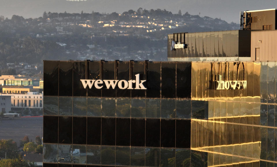 SAN MATEO, CALIFORNIA - NOVEMBER 01: In an aerial view, a sign is posted on the exterior of a WeWork office on November 01, 2023 in San Mateo, California. Shares of WeWork dropped over 35 percent in Wednesday morning trading following news reports that the New York-based company is planning to file for Chapter 11 bankruptcy. (Photo by Justin Sullivan/Getty Images)