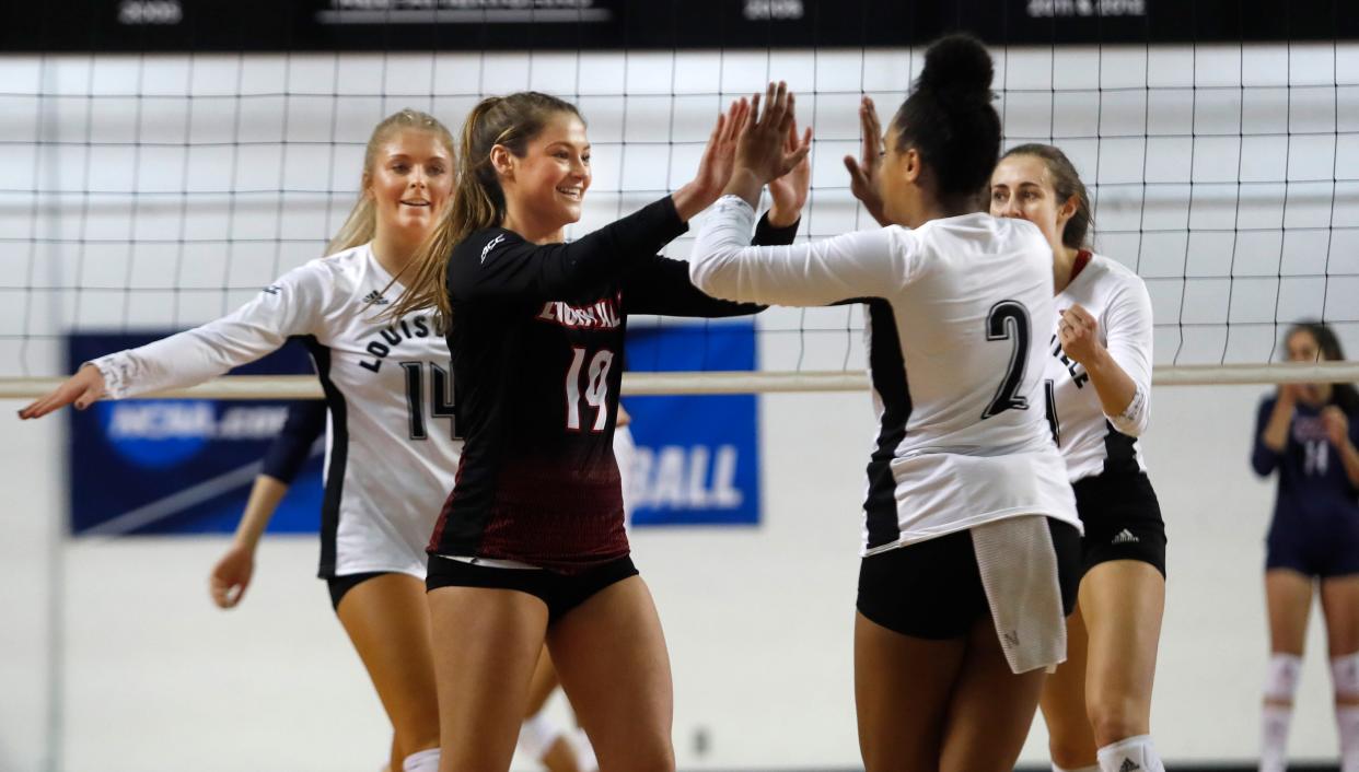 Louisville’s Elena Scott (19) celebrates with Aydne Barlett after the Cards scored against UIC. The Cardinals won the match to advance to the NCAA Tournament's second round. Dec. 3, 2021