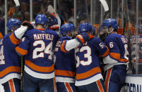 New York Islanders defenseman Ryan Pulock (6) and teammates celebrate a 3-2 win over the Tampa Bay Lightning in Game 4 of an NHL hockey Stanley Cup semifinal Saturday, June 19, 2021, in Uniondale, N.Y. (AP Photo/Jim McIsaac)