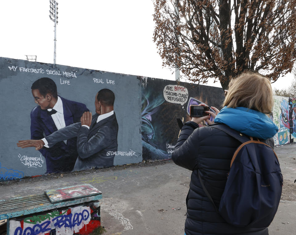 BERLIN, GERMANY - MARCH 30: Will Smith graffiti of Dominican artist Jesus Cruz Artiles aka EME Freethinker adorns the street in Berlin, Germany on March 30, 2022. Artist Artile's latest graffiti depicts the event when famous actor Will Smith slapped presenter Chris Rock on the stage during the night when 