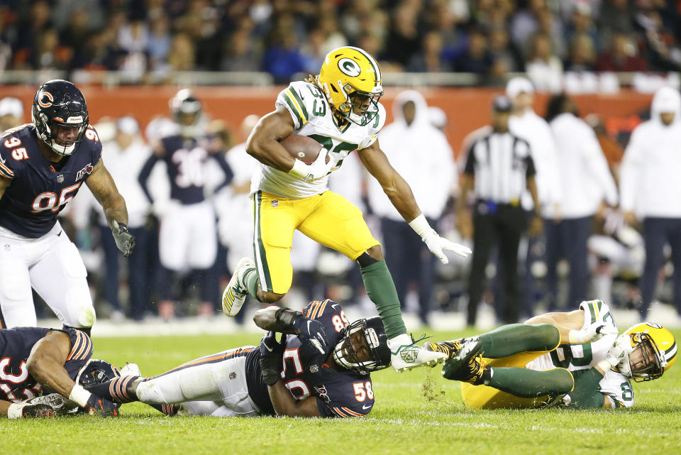 Aaron Jones #33 of the Green Bay Packers leaps over Roquan Smith #58 of the Chicago Bears during the game at Soldier Field on September 05, 2019 in Chicago, Illinois. (Photo by Nuccio DiNuzzo/Getty Images)