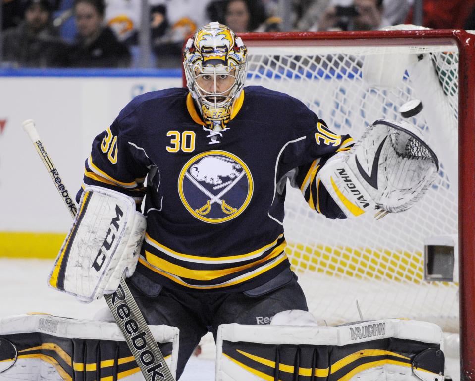 FILE - Buffalo Sabres goaltender Ryan Miller reaches out with his glove to stop the puck during an NHL hockey game against the Carolina Hurricanes in Buffalo, N.Y., Tuesday, Feb. 25, 2014. The Buffalo Sabres are honoring their franchise goalie leader in wins and games played by retiring Ryan Miller's No. 30 jersey next season.
The team made the announcement by releasing a video on Friday, June 10, 2022, which showed Miller being informed of the honor while touring the Sabres arena with his family. (AP Photo/Gary Wiepert, File)