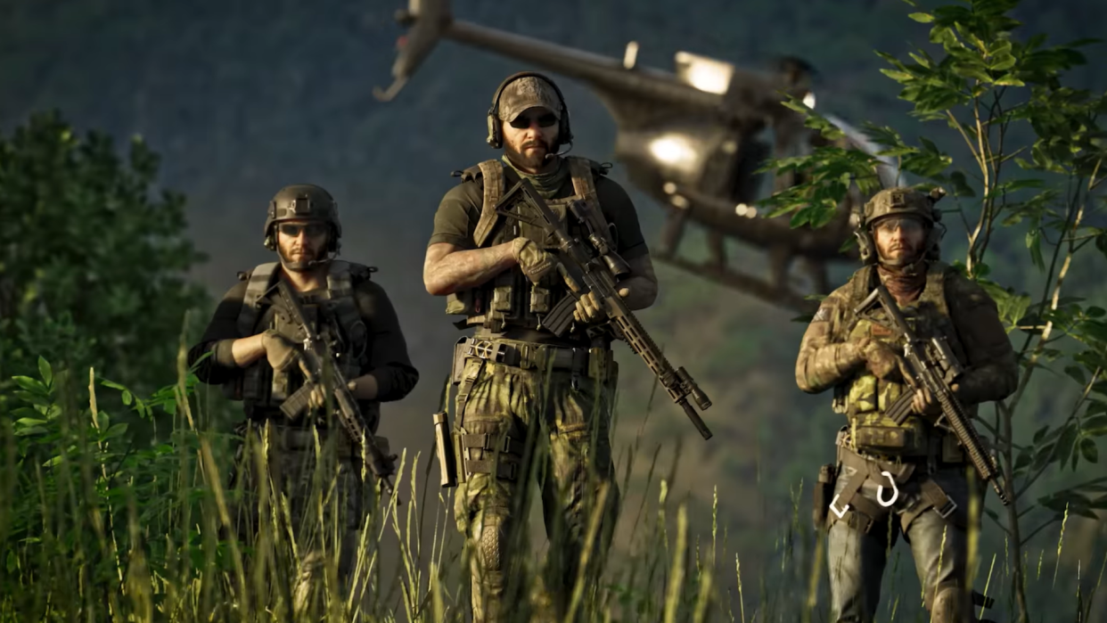  Three soldiers in camo holding guns and walking through long grass. 