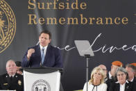 Florida Gov. Ron DeSantis speaks alongside first lady Jill Biden, second from right, and Miami-Dade County Mayor Daniella Levine Cava, right, during a remembrance event at the site of the Champlain Towers South building collapse, Friday, June 24, 2022, in Surfside, Fla. Friday marks the anniversary of the oceanfront condo building collapse that killed 98 people in Surfside, Florida. The 12-story tower came down with a thunderous roar and left a giant pile of rubble in one of the deadliest collapses in U.S. history. (AP Photo/Wilfredo Lee)