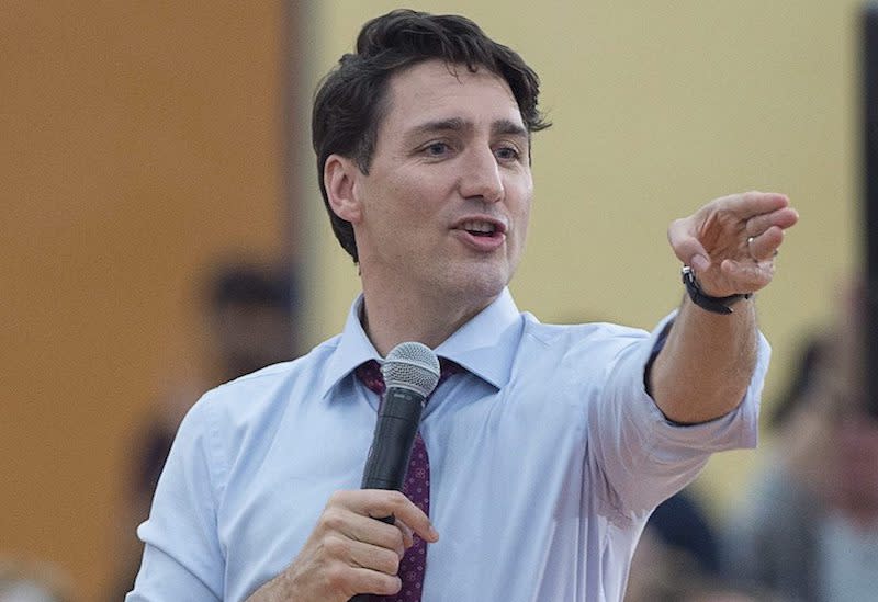 Prime Minister Justin Trudeau points to a member of the audience at a town hall meeting in Lower Sackville, N.S., Jan. 9, 2018, where he was asked about the federal government’s $10.5 million payout to Omar Khadr. Photo from The Canadian Press.