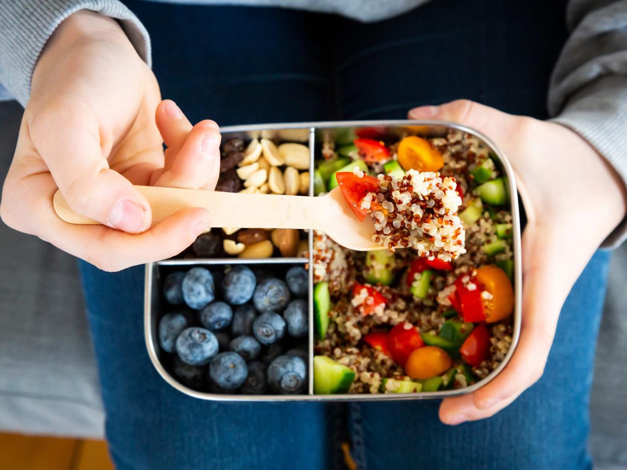 A healthy lunchbox with quinoa, nuts and blueberries.