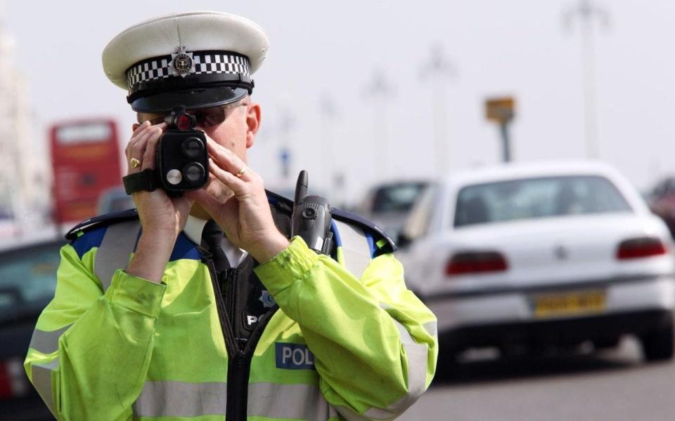 officer using a speed gun - Credit: ENP / Alamy