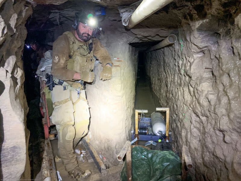 A U.S. Customs and Border Protection agent maps tunnel to Tijuana