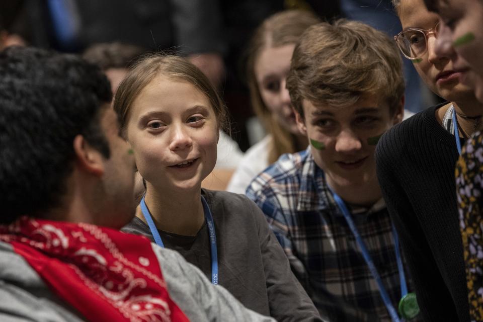 Climate activist Greta Thunberg, second left, talks with other climate activists youth at the COP25 climate talks summit in Madrid, Friday Dec. 6, 2019. Thunberg arrived in Madrid Friday to join thousands of other young people in a march to demand world leaders take real action against climate change. (AP Photo/Bernat Armangue)